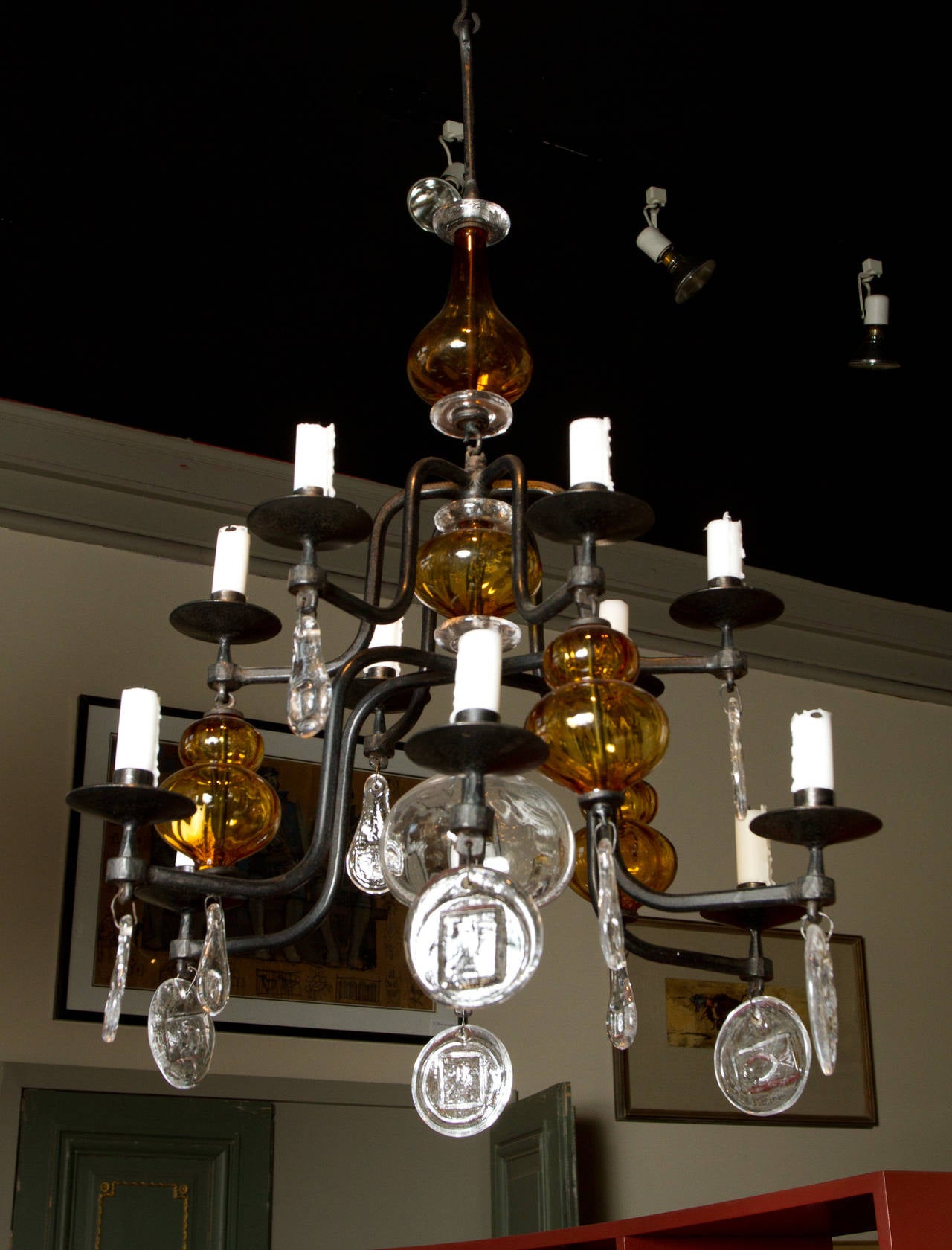 Rare wrought iron, clear and amber glass ten light chandelier by Erik Hoglund for Kosta Boda featuring typical beautifully moulded glass pendants.