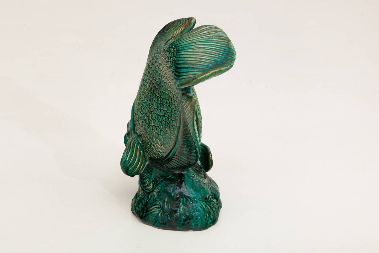 Beautiful emerald green glazed ceramic sculpture representing a fish.
France, circa 1940.