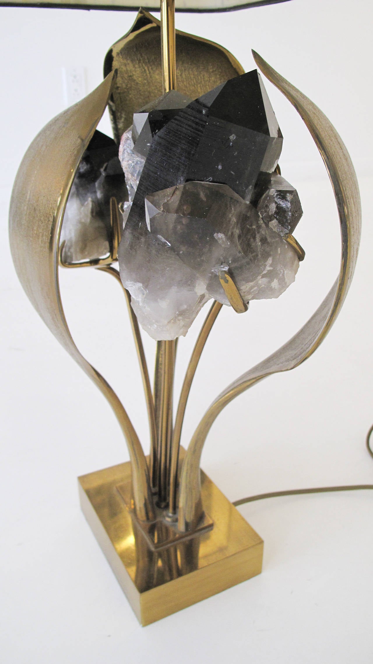 Polished cast bronze table lamp inset with large smoked amethyst crystals, enclosed by three cast bronze leaves. Signed 