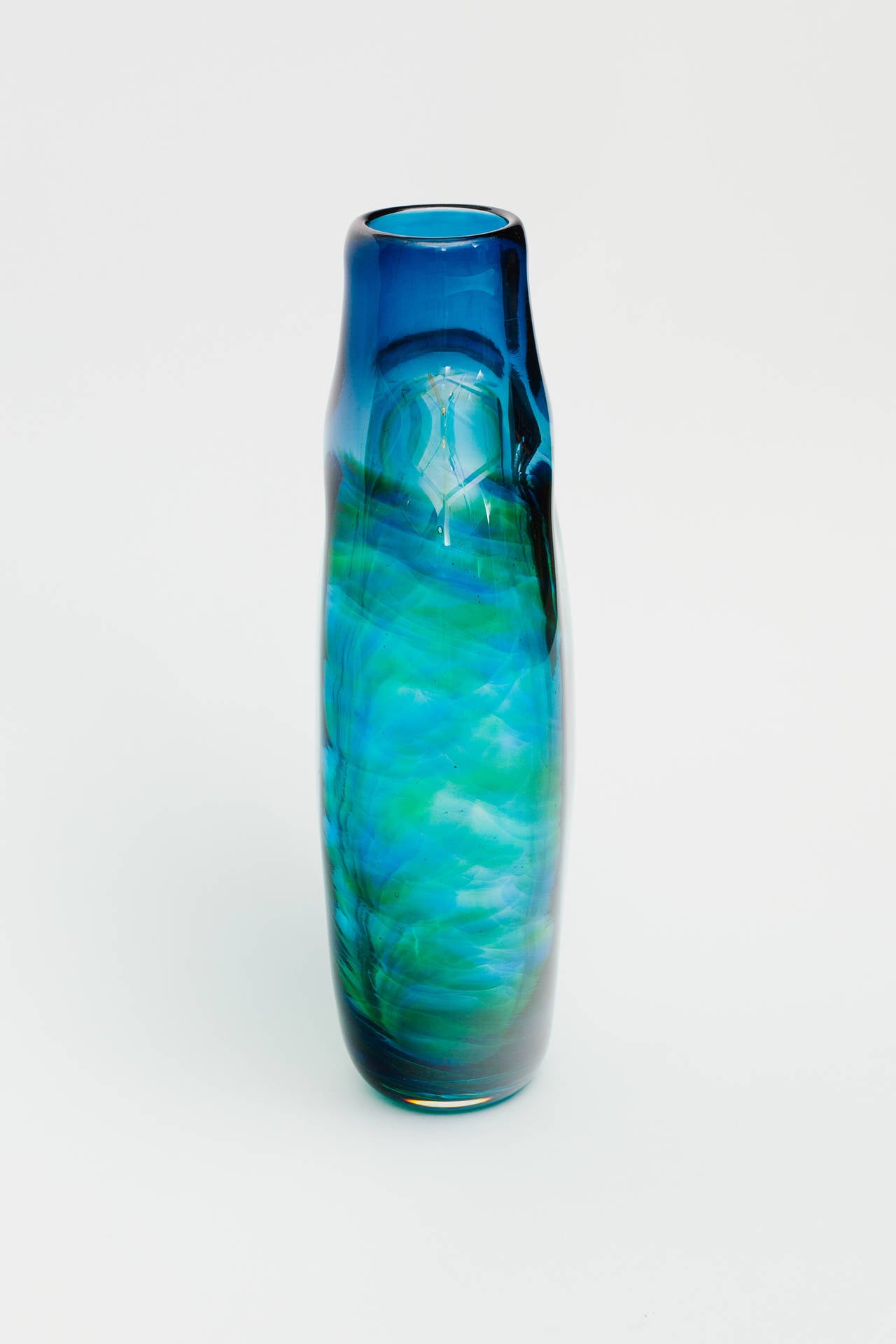 Vibrant blue blown glass bottle shape vase .