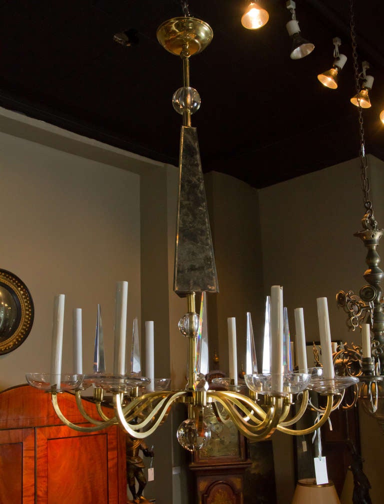 Polished brass, mirror and crystal eight light chandelier.