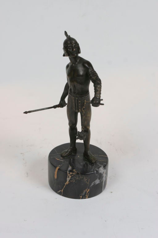 Art Deco period patinated bronze figure of a gladiator on porto-nero marble base.