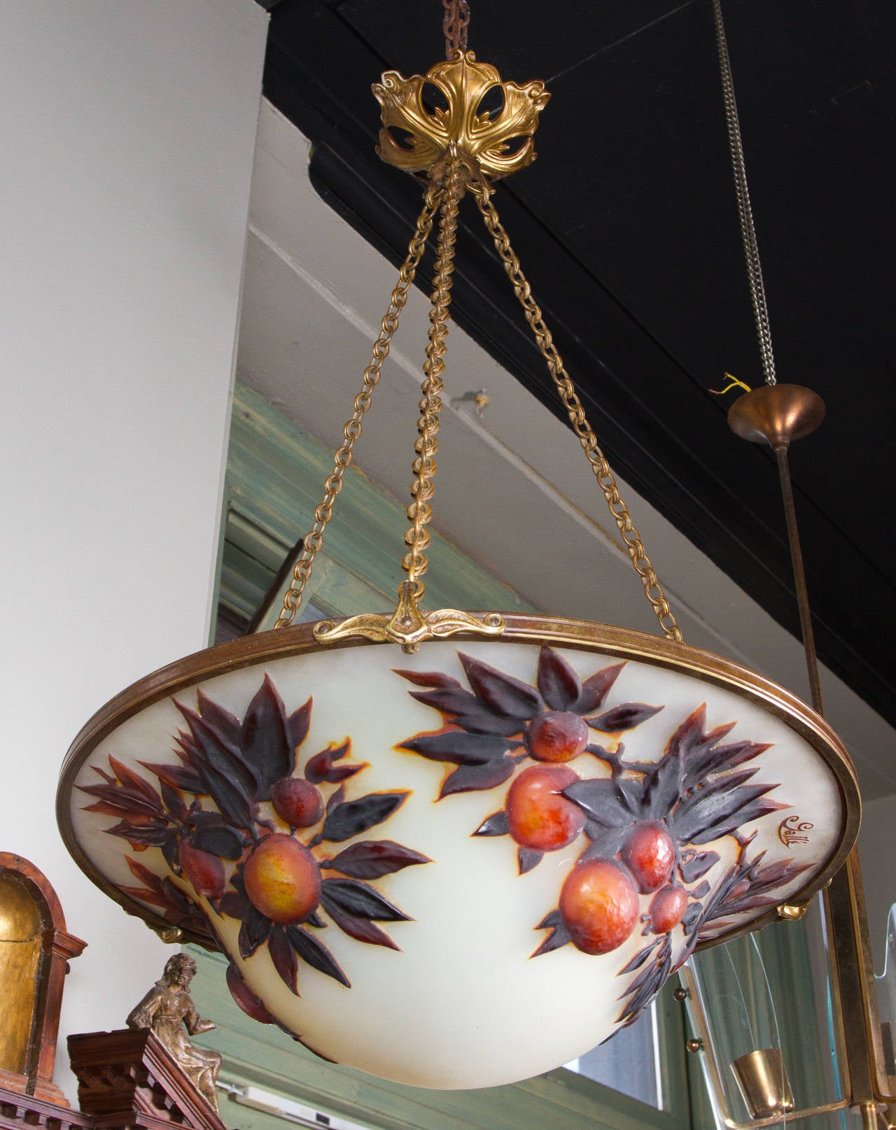 Rare Art Nouveau, Cameo glass and cast bronze  chandelier by Émile Gallé. The unusual highly raised overlay depicting a fruiting orange branch on a white ground. Signed: Gallé. Suspended by original cast bronze chain bearing date stamp: 1904.