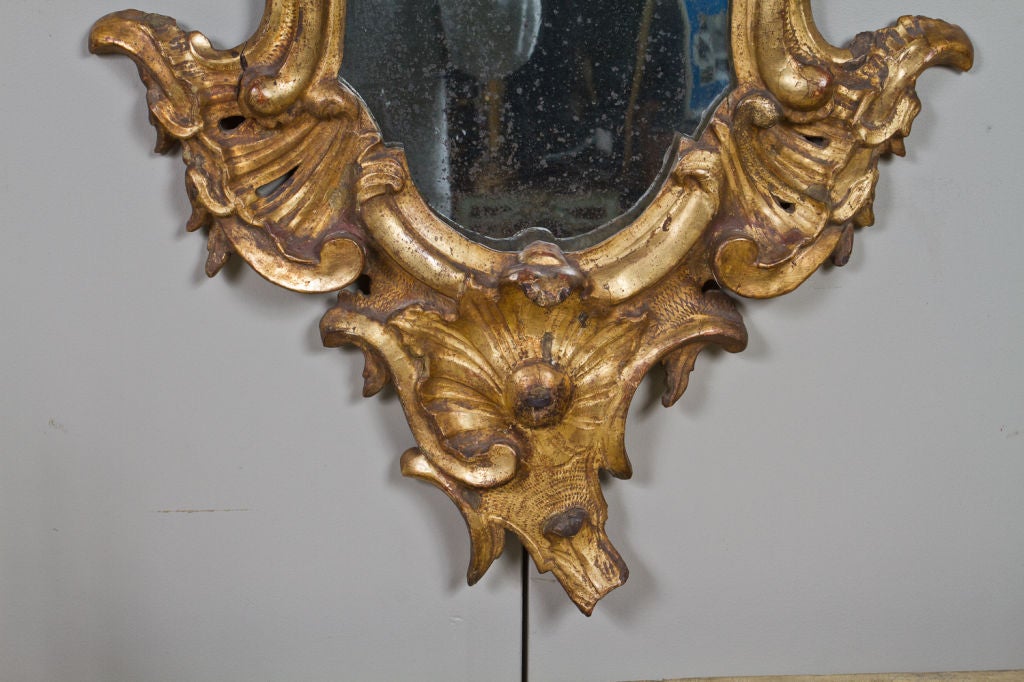 Finely carved 18th century Venetian Rococo giltwood mirror.