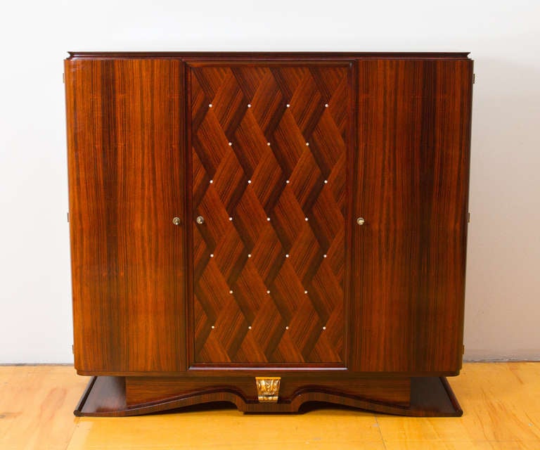 Beautiful matched pair of rosewood and mother of pearl marquetery art deco cabinets with gilt wood relief decorations , in the manner of Lucien Rollin.
