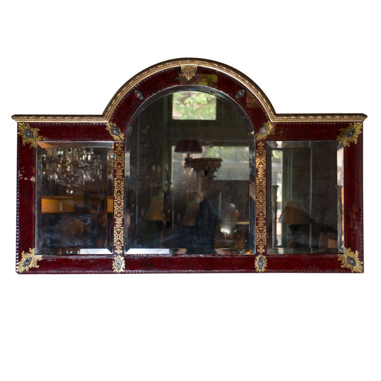 Unusual scarlet and gilt églomisé etched glass overmantle three-part mirror in the English early 18th century style.