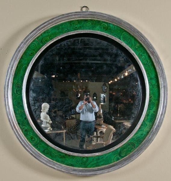 A large and unusual silver-gilt round convex mirror decorated with a faux painted malachite border.  English Regency period (circa 1810) with later gilding and painted decoration.