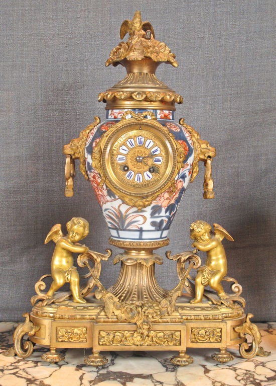 Louis XV style gilt bronze and porcelain Imari mantel clock and garniture.