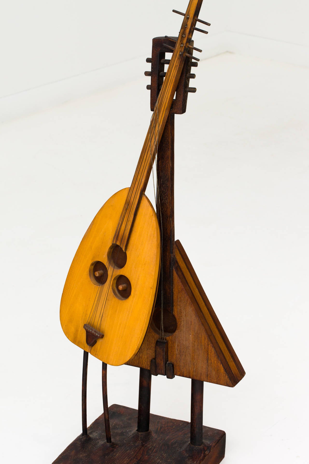 Whimsical Cubist inspired sculpture depicting anthropomorphic guitars dancing. Signed EW, 70.