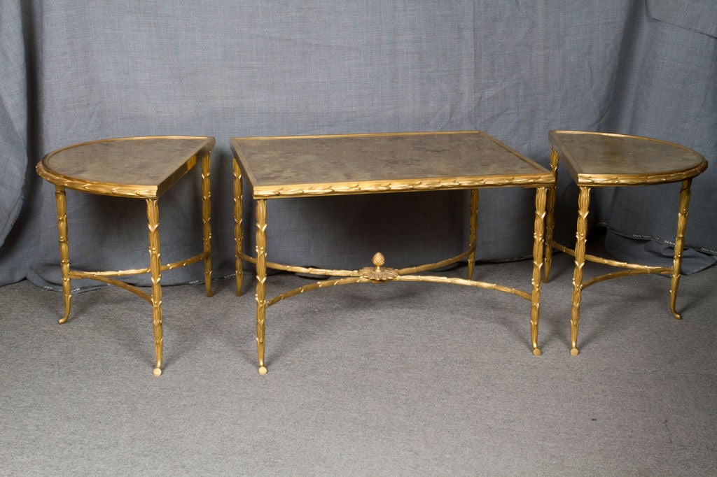 Gilt bronze oxidized glass top, three part, oval coffee table by Maison Bagues.