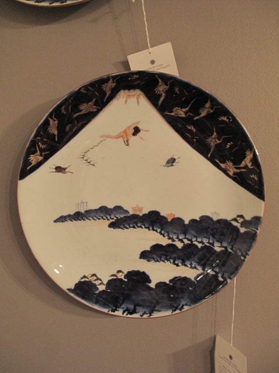 Pair of Japanese Imari chargers showing cranes and Mount Fuji.