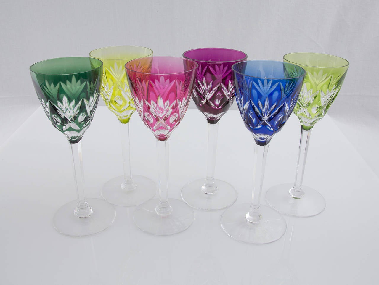 Beautiful set of six tall stemmed colored wine glasses featuring a hand-cut-to-clear pattern by famed Belgian glass maker Val St. Lambert. Each glass measures approx. 7.5” tall and one glass is signed Val St. Lambert, circa 1950s.