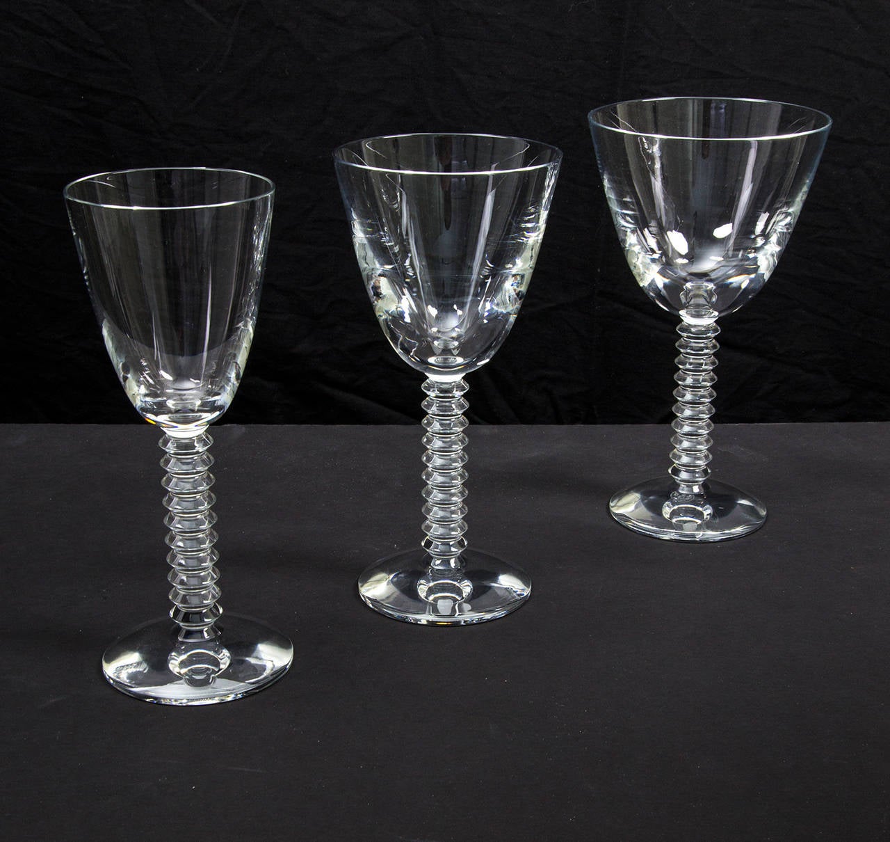 Exquisite set of 36 crystal glasses by Baccarat in the Lalande pattern, comprising 12 crystal tall water goblets, 12 crystal white wine glasses and 12 crystal red wine glasses. Each glass measures approximately: 7.5” tall. Classic and timeless!