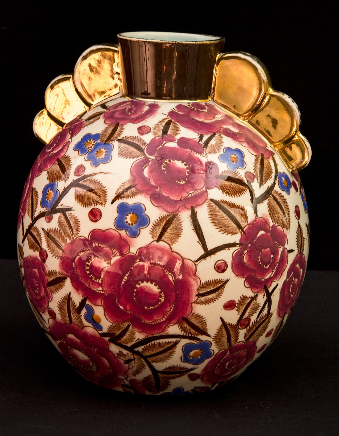 Beautiful hand-painted vase with overall flower designs on bulbous body, gilt handles0, hallmarked Boch Frères La Louvière, Made in Belgium Fabrication Belge Boch Fres 1277 approximately 7.5” high, circa 1930s. Classic and timeless!