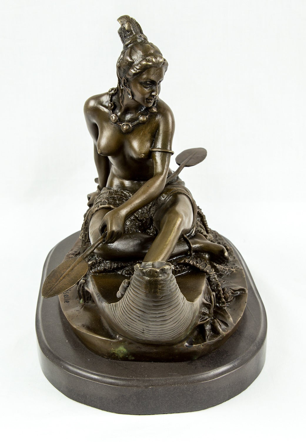 Featuring a beautiful Native American Indian maiden sitting in a canoe; bronze sculpture, signed Duchoiselle; entitled 