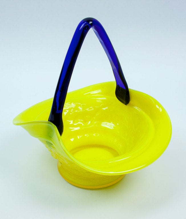 Mid-Century Modern handblown Bohemian glass basket, decorated with a garland of grape vines. Wonderful yellow with applied blue handle to welcome in Spring!