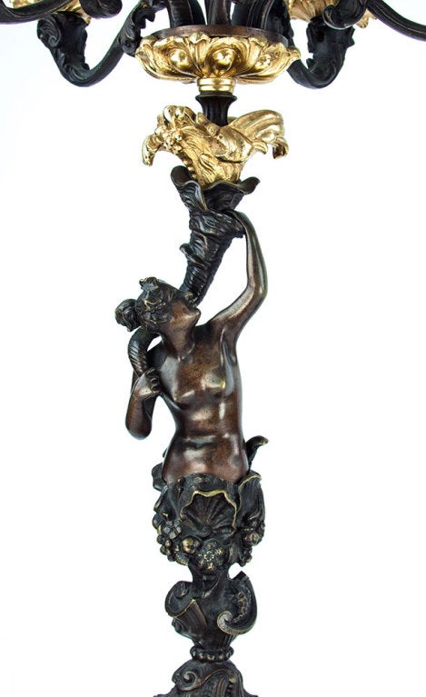 Rare and dramatic pair of Napoleon III patinated bronze and gilt bronze six light candelabra  portraying the Greek deities, Poseidon and his wife Amphritite rising out of the waves; expertly cast and designed! Bearing the bold neoclassical imagery