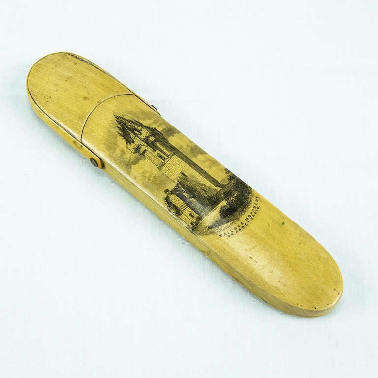 Treen Mauchline ware straight edge razor, depicting the Wallace Monument on Abbey Craig on its fold over box. The velvet lined interior holds a celluloid and steel razor.