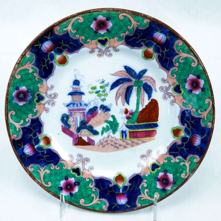 Set of three Boch Freres Keramis faience plates with polychrome Orientalist style decor in rich colors with dominant canton green border, centered by fanciful depiction of Japanese pagoda, "Yedo" pattern. Impressed maker's mark to reverse.