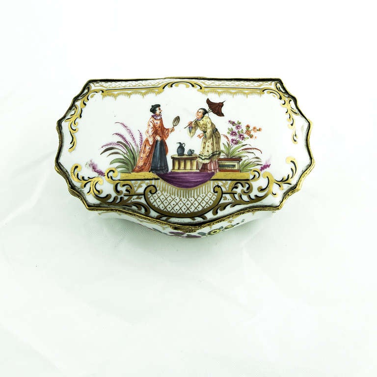 Porcelain trinket box; hand paintedCourting Scene of an Oriental Couple on top with flowers and gilding decorations inside and out; The hinged mount is bronze with shell clasp. measures approx. 4.5 inches long, 3 inches wide and 1.75 inch high.