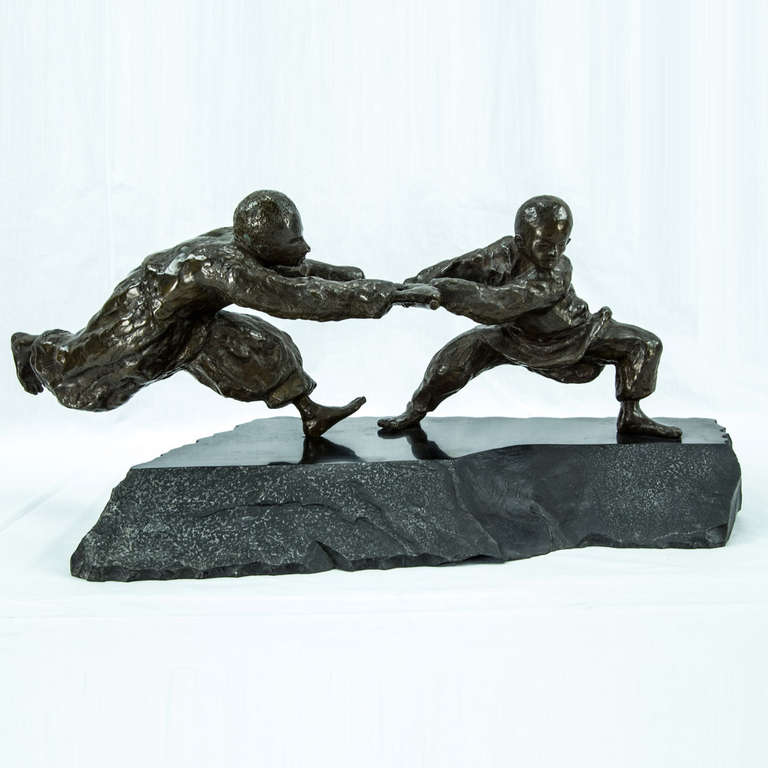Wonderful bronze sculpture depicting boys at play; on natural polished granite; signed and dated: Agnes Farkas; 12/1980.