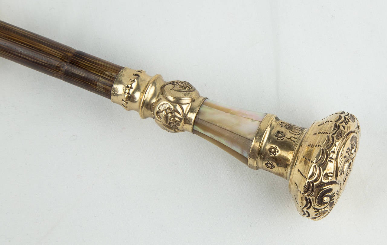 Stately Victorian period desk or tabletop umbrella or parasol handle embossed gilt silver, bamboo and mother-of-pearl decoration that has been made into a fabulous magnifier; dated: 1854-1904; approximate size: 9.5 
