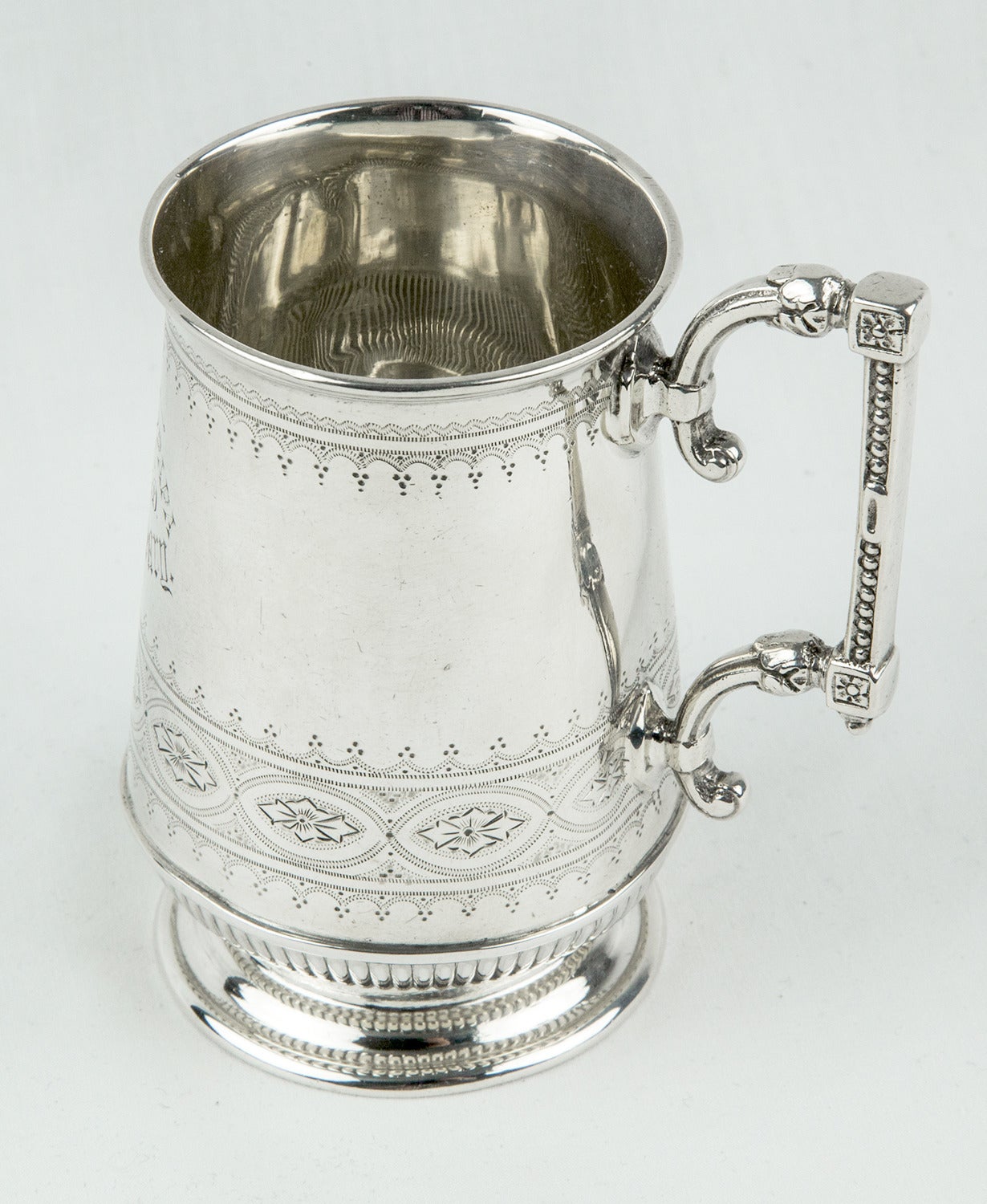 Superb Christening mug with applied, chased and engraved decoration on body and handle; fully hallmarked corresponding to: W.W. Harrison & CO. Sheffield, England, circa 1888; measuring 3.5” high and weighing approximate 149.4gm. A wonderful gift or