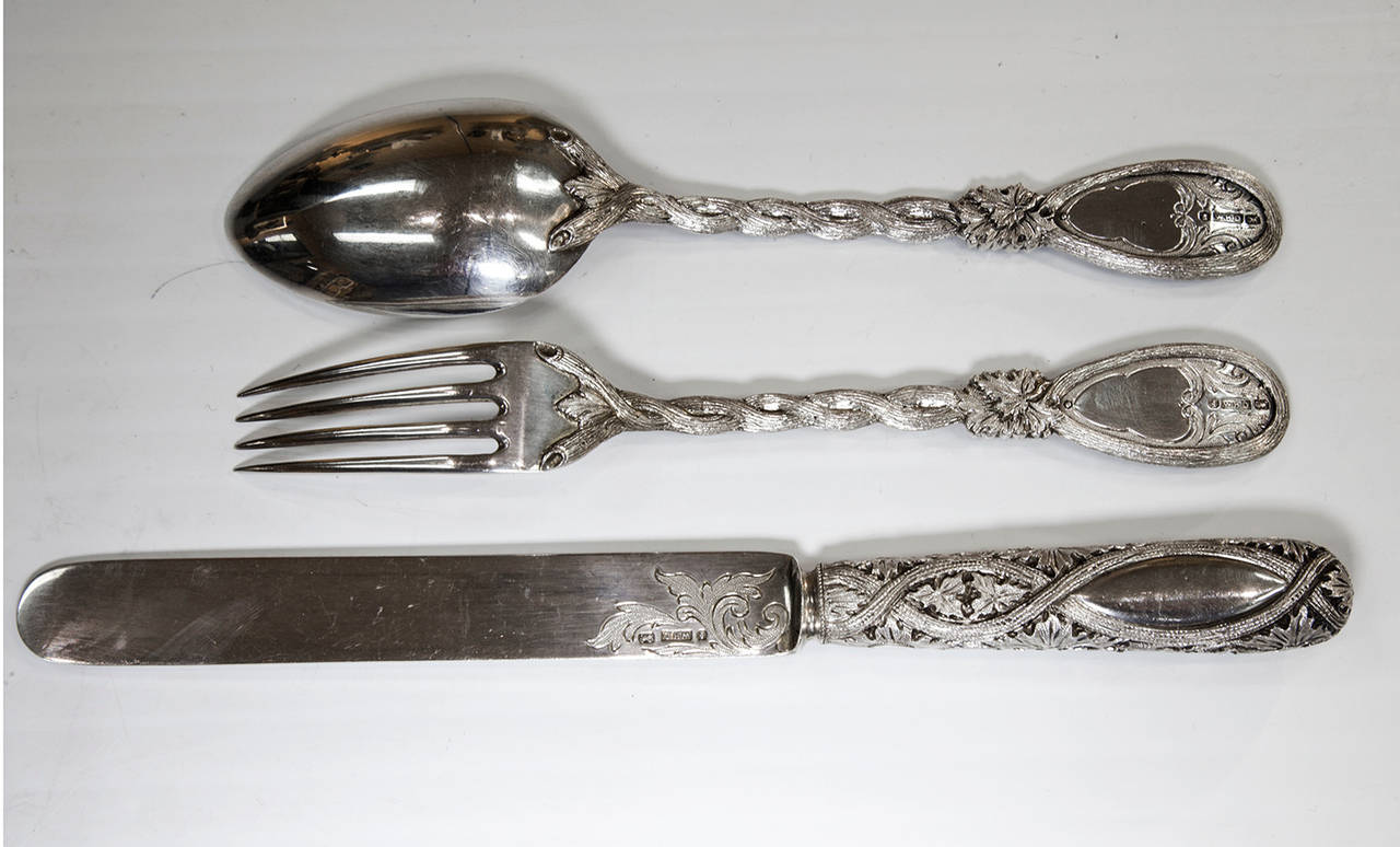 Outstanding christening set, consisting of a dessert sized spoon, knife and fork; each piece beautifully decorated with heavy foliate, branch and beaver designs plus a blank shield (meant for the recipients initials). The unique pattern is repeated