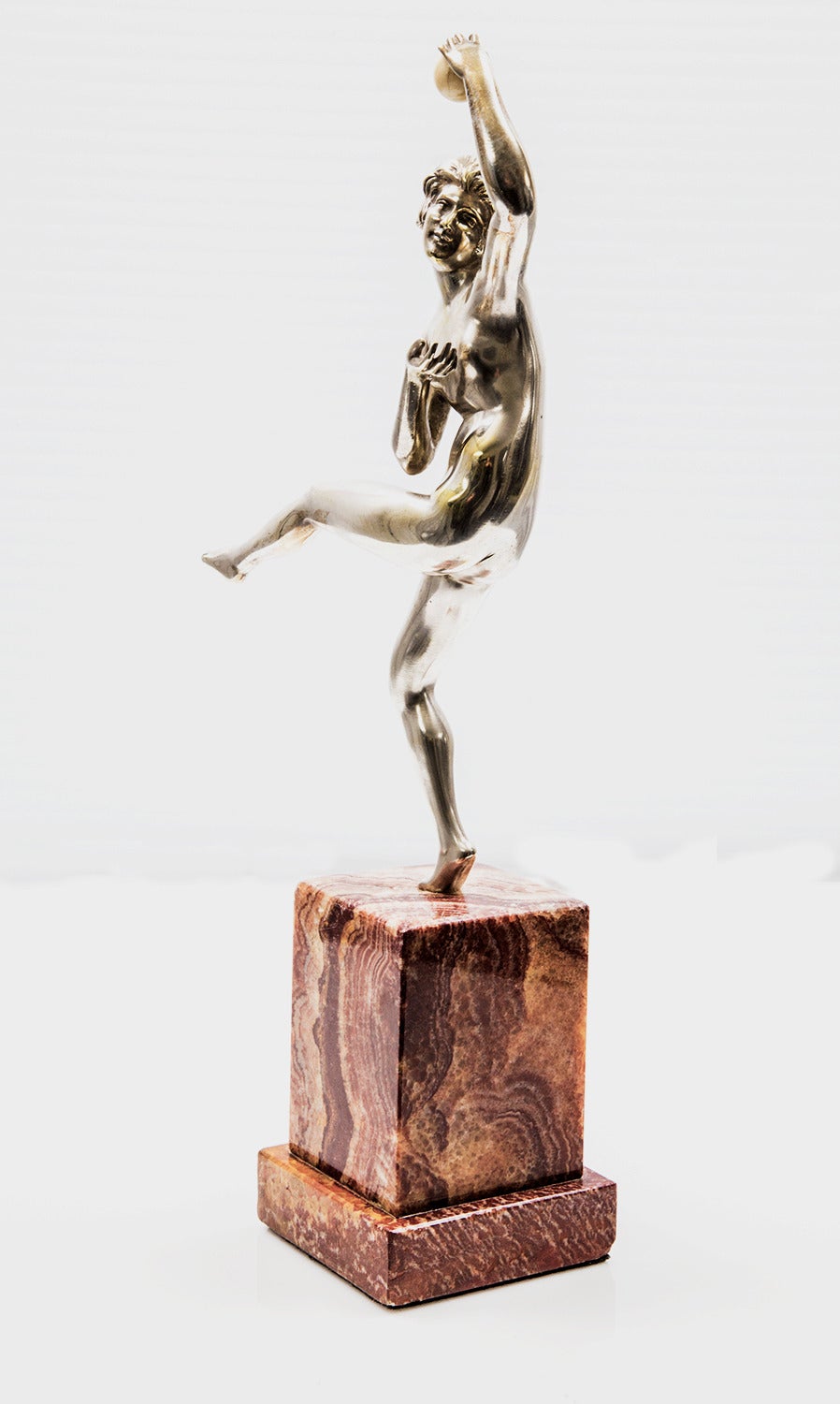 Rare silvered bronze figure depicting a nude dancer, poised on one leg with a ball in hand on marble base; Signature: Guiraud Rivière, engraved to marble; Approx. 13” high, including 4” base. By Maurice Guiraud Riviere, Toulouse (1881-1947) an