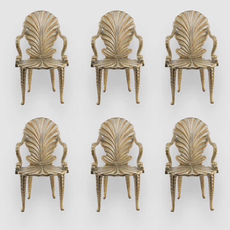 Set of Six Fabulous Painted and Parcel Gilt Carved Wood Grotto Shell form Dining Armchairs with Dolphin Motif Arm Rests. C1960s. Venetian Grotto furniture was originally created for the artificial grottos of Royal palace gardens. Traditionally