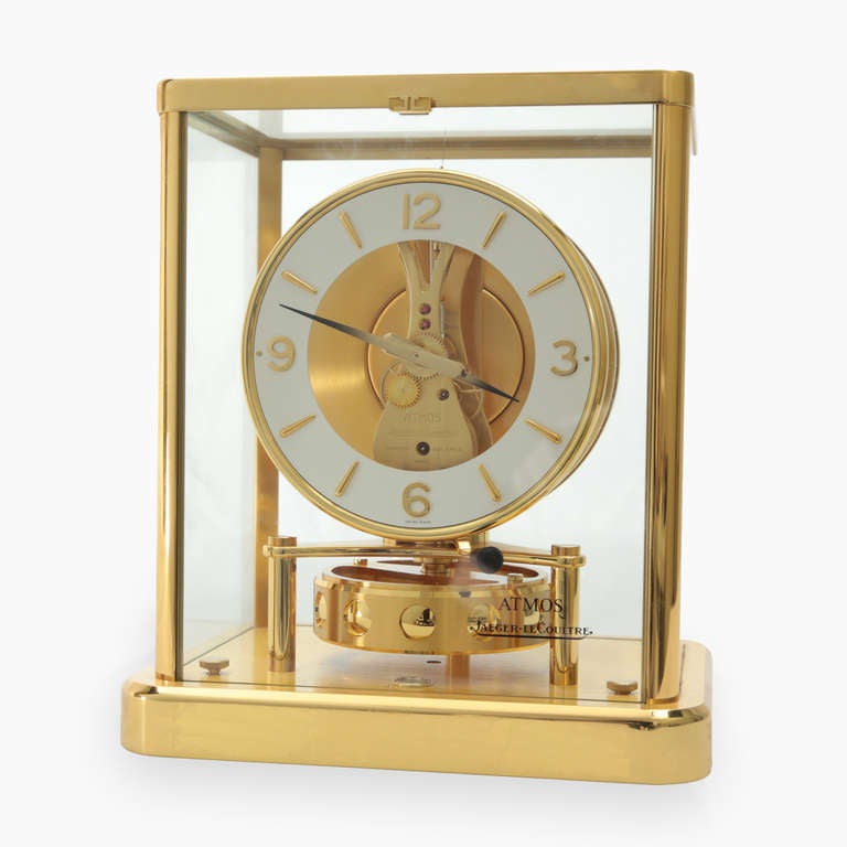 Jaeger Le-Coultre Atmos Clock with a glass case framed in brass; Perpetual thirteen jewels Movement, never needs winding, runs silently and accurately powered by a combination of temperature and humidity changes. Marked on movement: Atmos Jaeger-Le