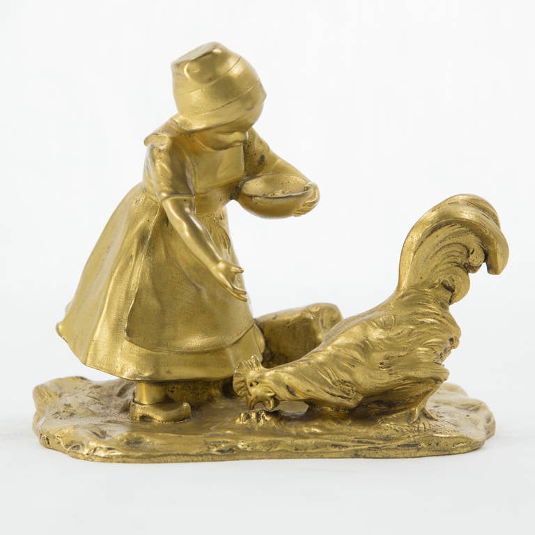 Antique late 19th century Viennese gilt bronze figurine, depicting a girl feeding a rooster; signed Gruber, Austrian sculptor Franz Gruber (1878-1945) and a foundry mark; approx. Size: 4” high x 5” long x 3” wide.