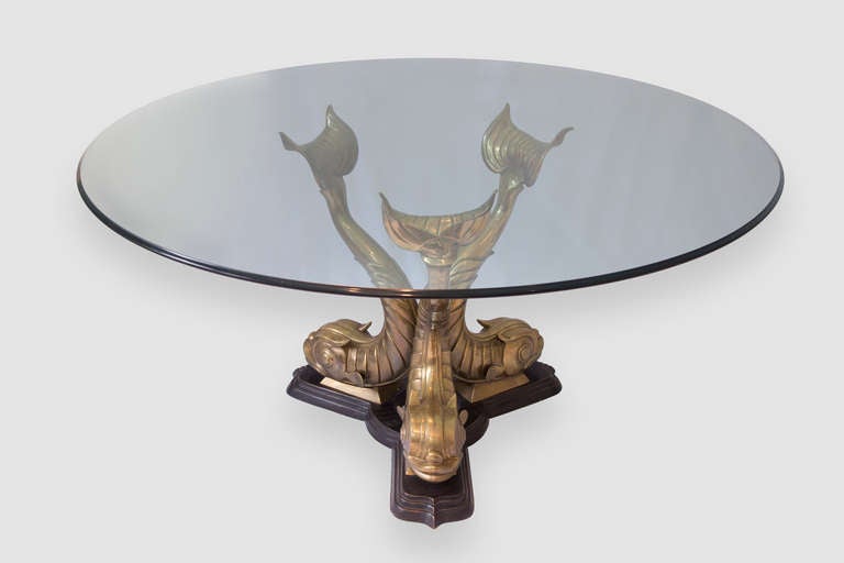 Spectacular Dining Table, beautifully detailed with a Trio of Dolphins, made of solid Bronzed Brass; the glass top rests on the fins. Table is shown in the photos with a 60