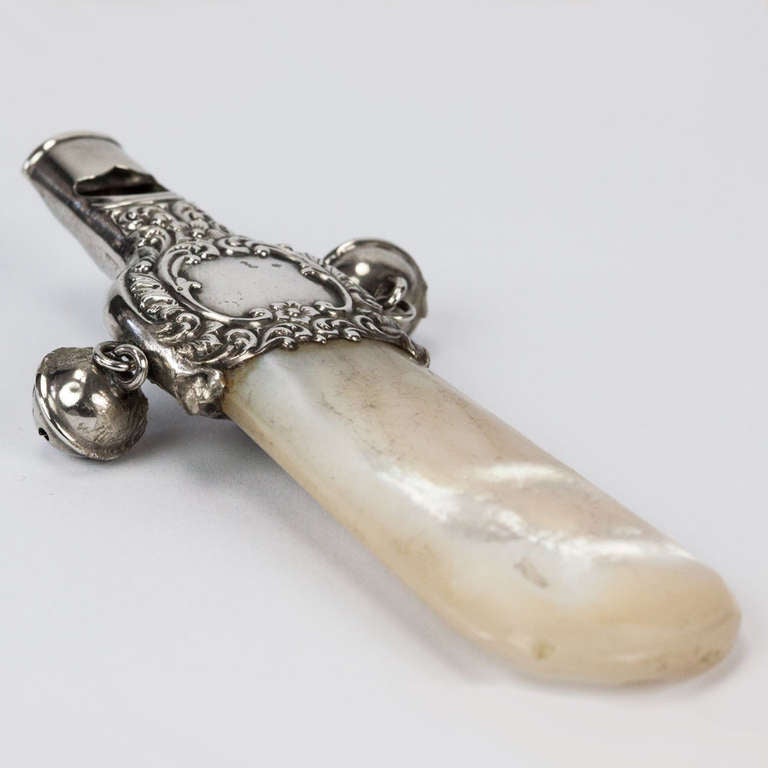 Antique Baby Rattle Sterling Silver with Mother of Pearl Teether
Wonderful Baby Rattle Silver with Mother of Pearl Teether, a Whistle and two little bells. There is an attached hook where the rattle/whistle can be hung on the chatelaine or worn as