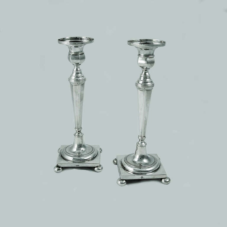 Beautiful pair of Continental silver candlesticks, terminating in a square base with ball feet to each corner, unweighted, maker's mark Q.A.P unidentified, Lisbon, Portugal; circa 1814-1816. Approximately 8.5