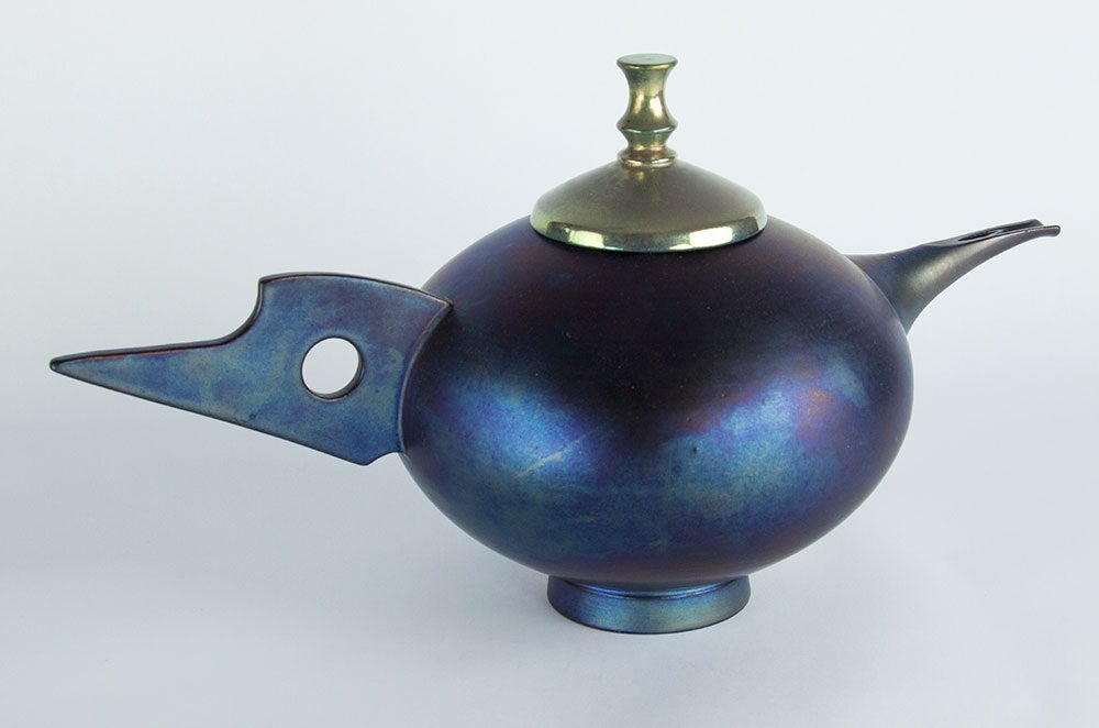 Fabulous and unusual modernist flared coupe shape ceramic stoneware teapot, reminiscent of the Bauhaus movement; iridescent blue with iridescent gold lid. Japanese mark on base; approximately size: 15 ½” long x 8” high (to top of finial); circa