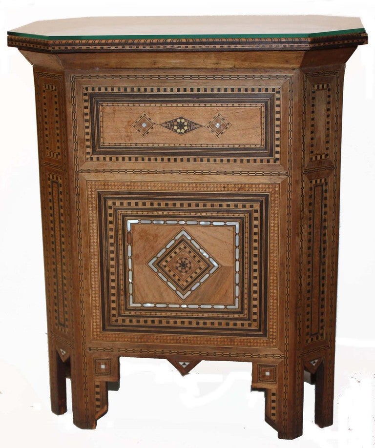 Syrian marquetry rectangular glass top table decorated overall with inlaid geometric forms in exotic woods and mother-of-pearl.