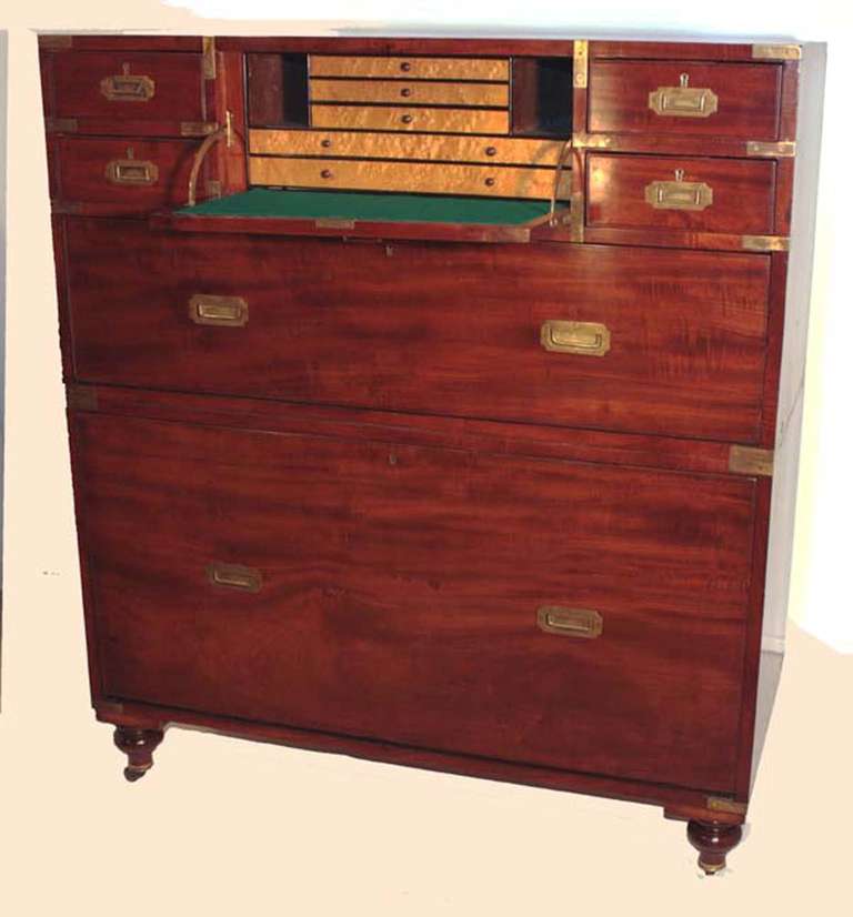 This particular campaign chest is remarkable in several ways. Unlike most such chests, it has  a wonderfully complete and well- appointed secretary drawer with birds-eye maple veneers, a secret drawer for your gold sovereign and a green baize-lined