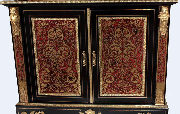 An exquisite bookcase done in the distinctive brass and tortoise shell inlay work inspired by Andre Charles Boulle. With ebony inlaid with brass framing the boulle work it is further enhanced by gilt bronze ornamentation. The bottom section has two