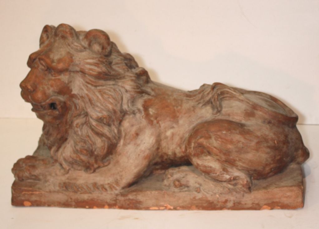 Pair of garden statuary moulded as lions facing each other.