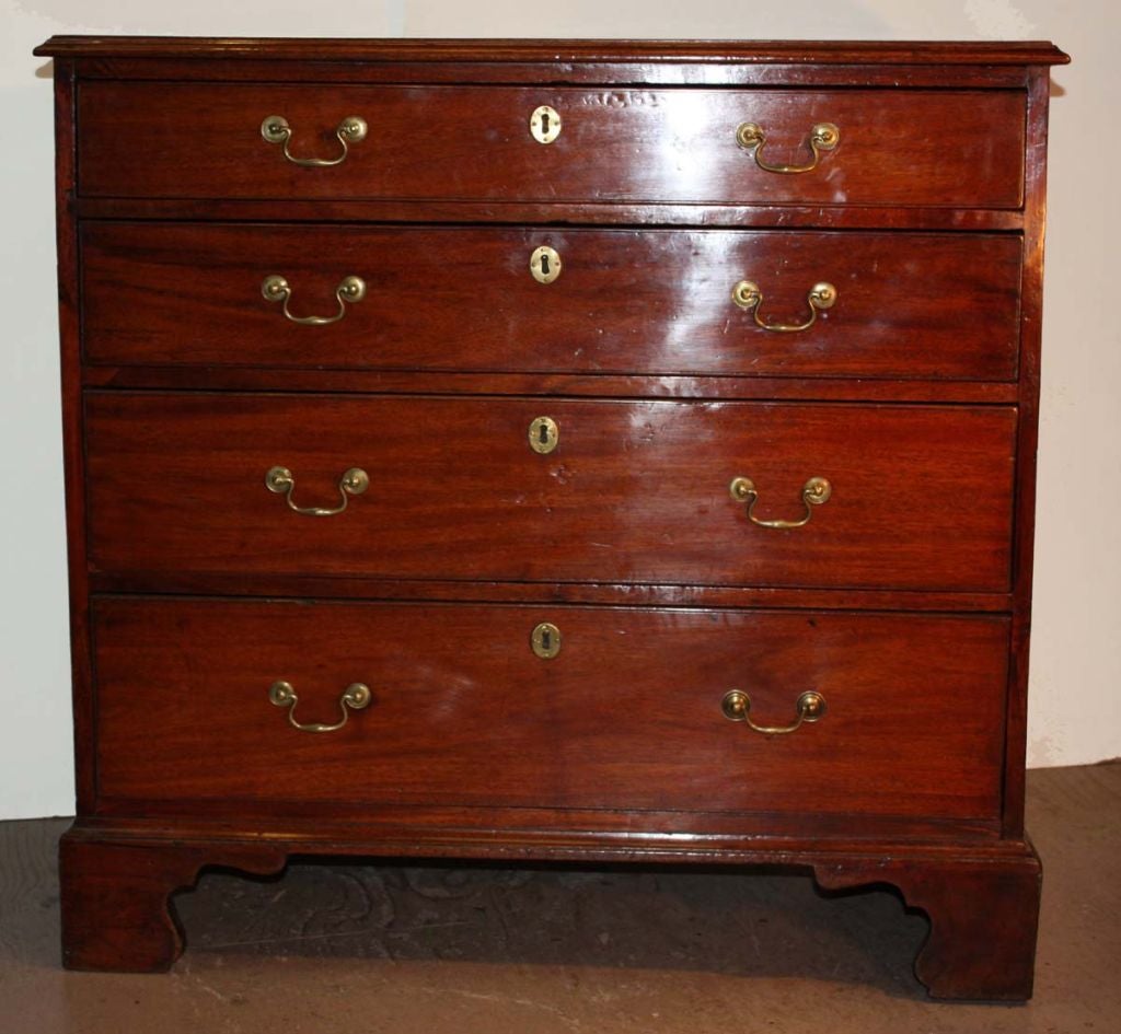 George III mahogany four drawer bachelor's chest with four graduated drawers, all with cockbeaded banding, and fitted with swan's neck pulls, raised on stepped shaped bracket feet.