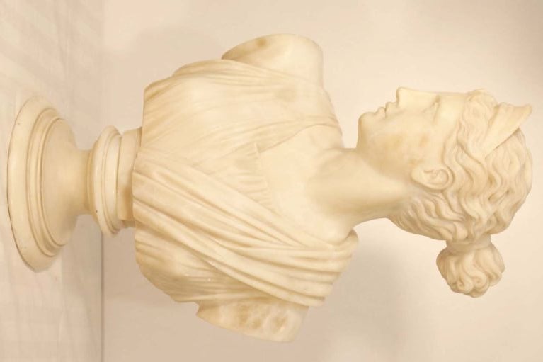 Alabaster bust of Diana the Huntress, after the full-length original from the antiquity, currently in the Louvre; resting on incurved marble  plinth.