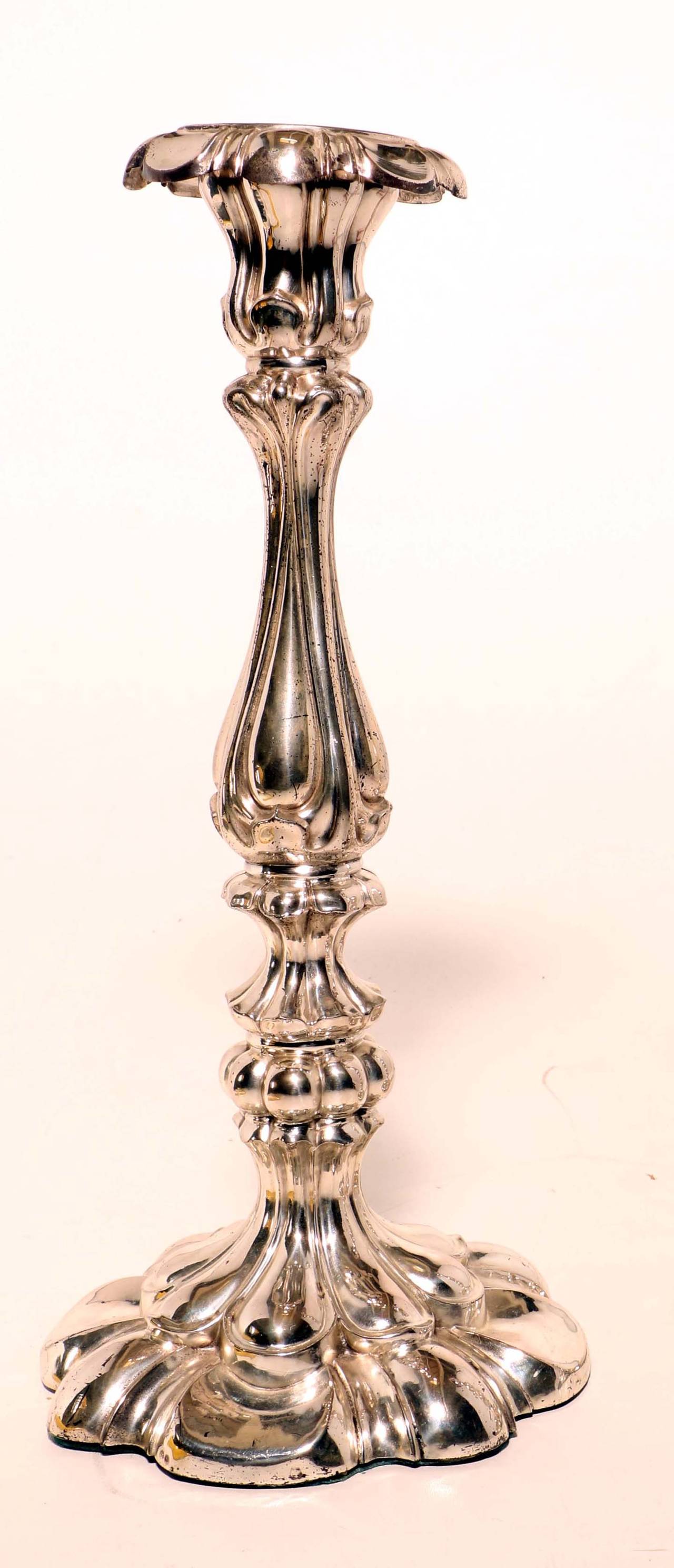 A pair of antique Polish silver Sabbath candlesticks each on lobed circular base and with lobed and knoped baluster stem. They have their original detachable drip pans, are stamped 12 and weighted and have small and indecipherable marks.
These