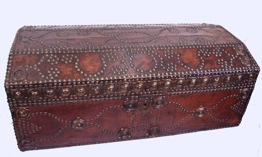 Leather covered wood trunk with brass studs and bail handles; the interior lined in printed cotton. Dating from th 19th century, these travelling chests were in frequent use. It is unusual to find one in  such good condition.