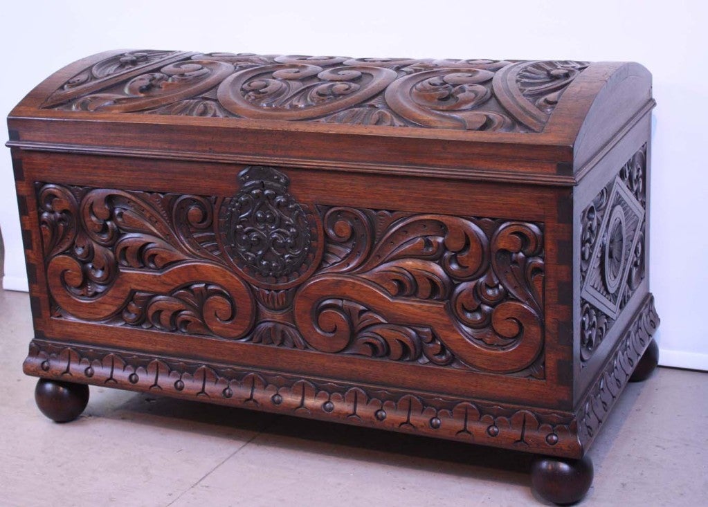 This carved mahogany chest is  in the Spanish colonial taste. It has  domed  hinged top and is  raised on ball feet: Front, sides and dome, all,  are heavily carved.