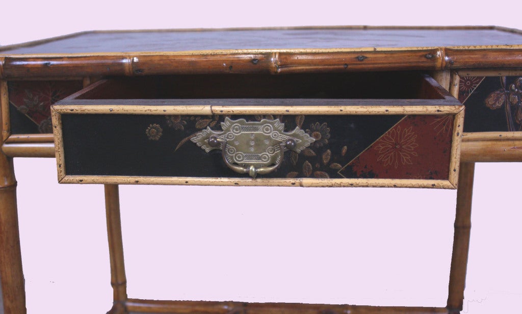 Victorian Japoniste bamboo and lacquered wood one drawer writing table on casters.