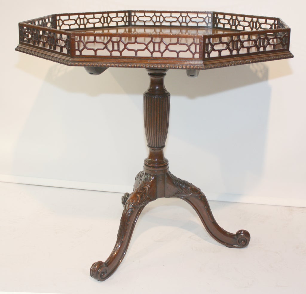 George III style mahogany table with fret-carved gallery ,  raised on reeded and turned pedestal and tripod legs. stamped  HG Plomer. 
Hubert Plomer was a Montreal cabinet maker specialising in high quality copies of Georgian furniture
