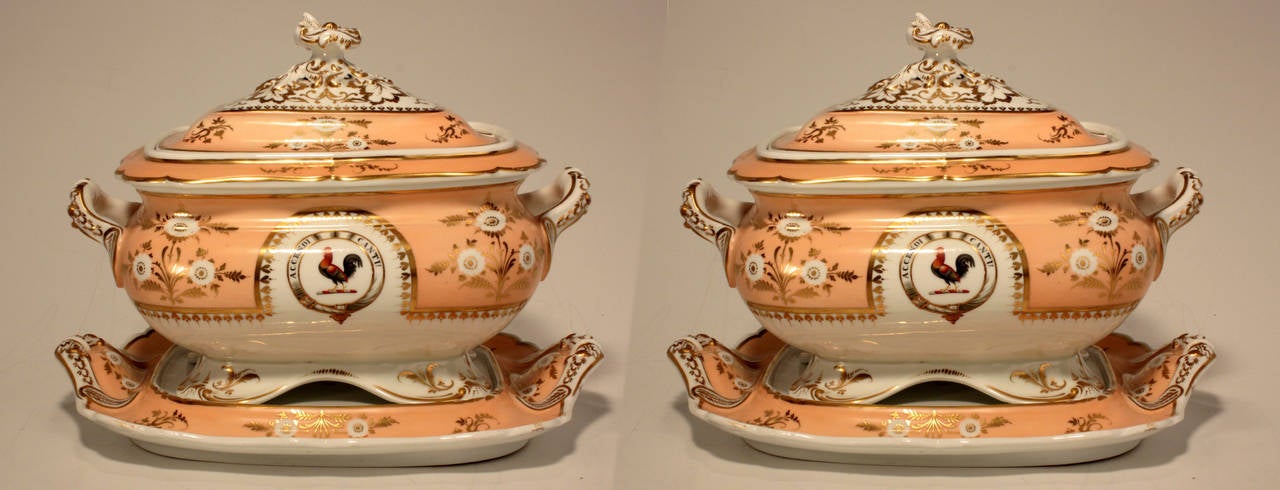 A rare pair of early 19th century Chamberlains Worcester Armorial footed oblong porcelain soup tureens, covers and stands; each white and peach colored body gilt with flowers and leaves. The covers are centered by elaborate finials the tureens are
