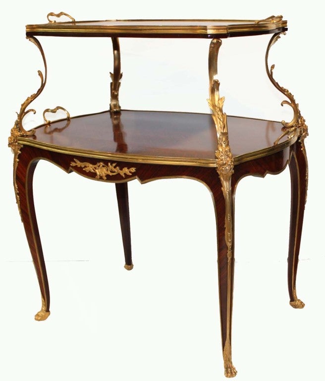 Louis XV style kingwood trellis parquetry two-tier tea table with twin handled rectangular trays, the serpentine borders banded in gilt bronze over tapering curved legs on gilt bronze  feet. The upper table, joined to the lower by curved foliate