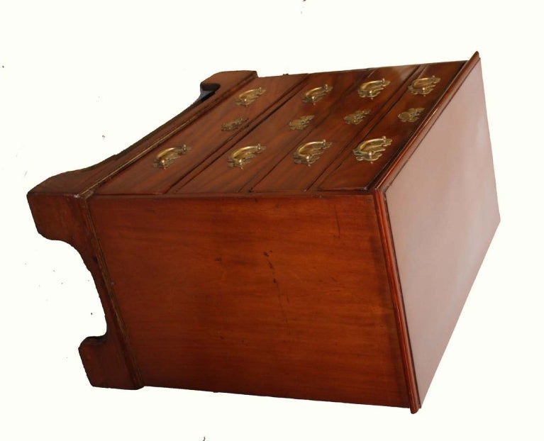 George III mahogany chest raised on bracket feet, fitted with four graduated drawers; original brass drawer pulls, escutcheons and replaced locks.